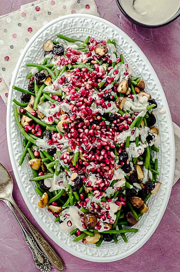 bid's eye view of a serving dish with green beans with tahini and pomegranates