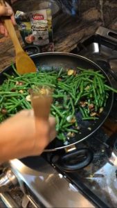 sautéing green beans in a pan