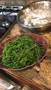 Green beans and and bowl with ice water