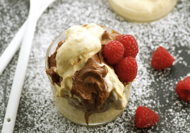 a clear cup with Chocolate and Peanut butter mousse with some raspberries. 