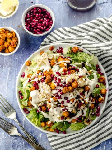 Overhead view of a roasted cauliflower salad with spiced chickpeas