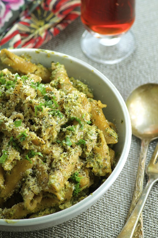 Side partial view of a white bowl of Penne Pasta with Cauliflower and Kale Walnut Pesto 