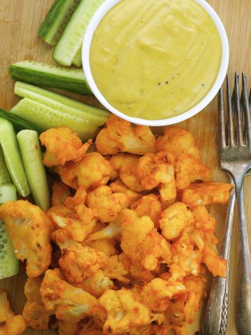 Spicy guilt free cauliflower buffalo wings with a creamy blue cheese sauce
