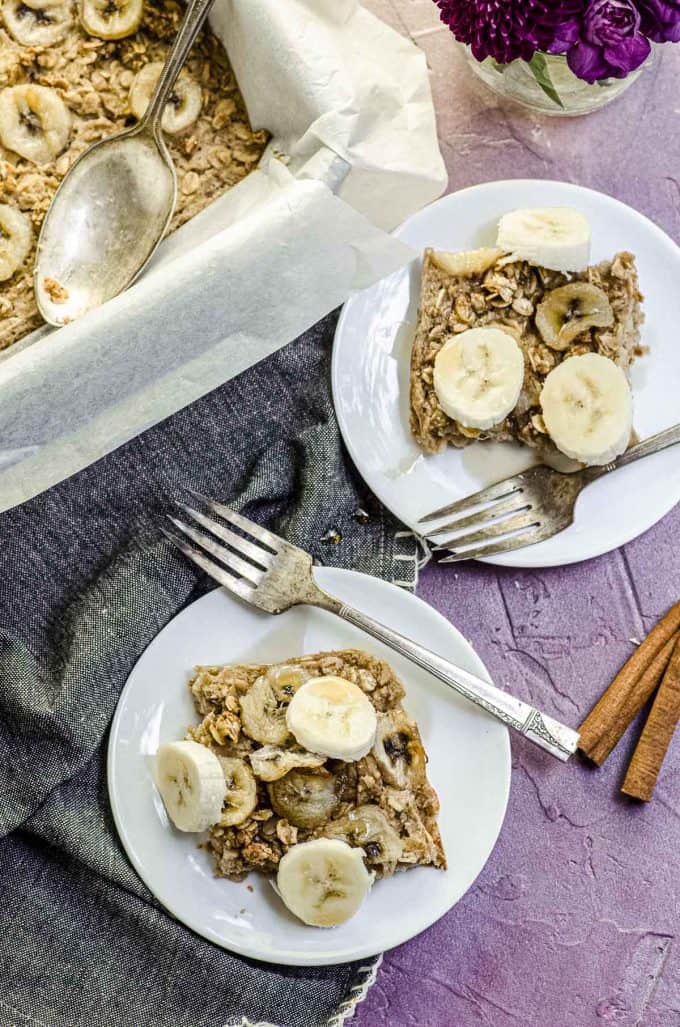 An overhead view of two mini plates with peanut butter banana baked oatmeal