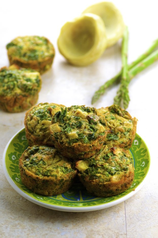 Side view of Individual Artichoke Asparagus Frittatas on a green plate.