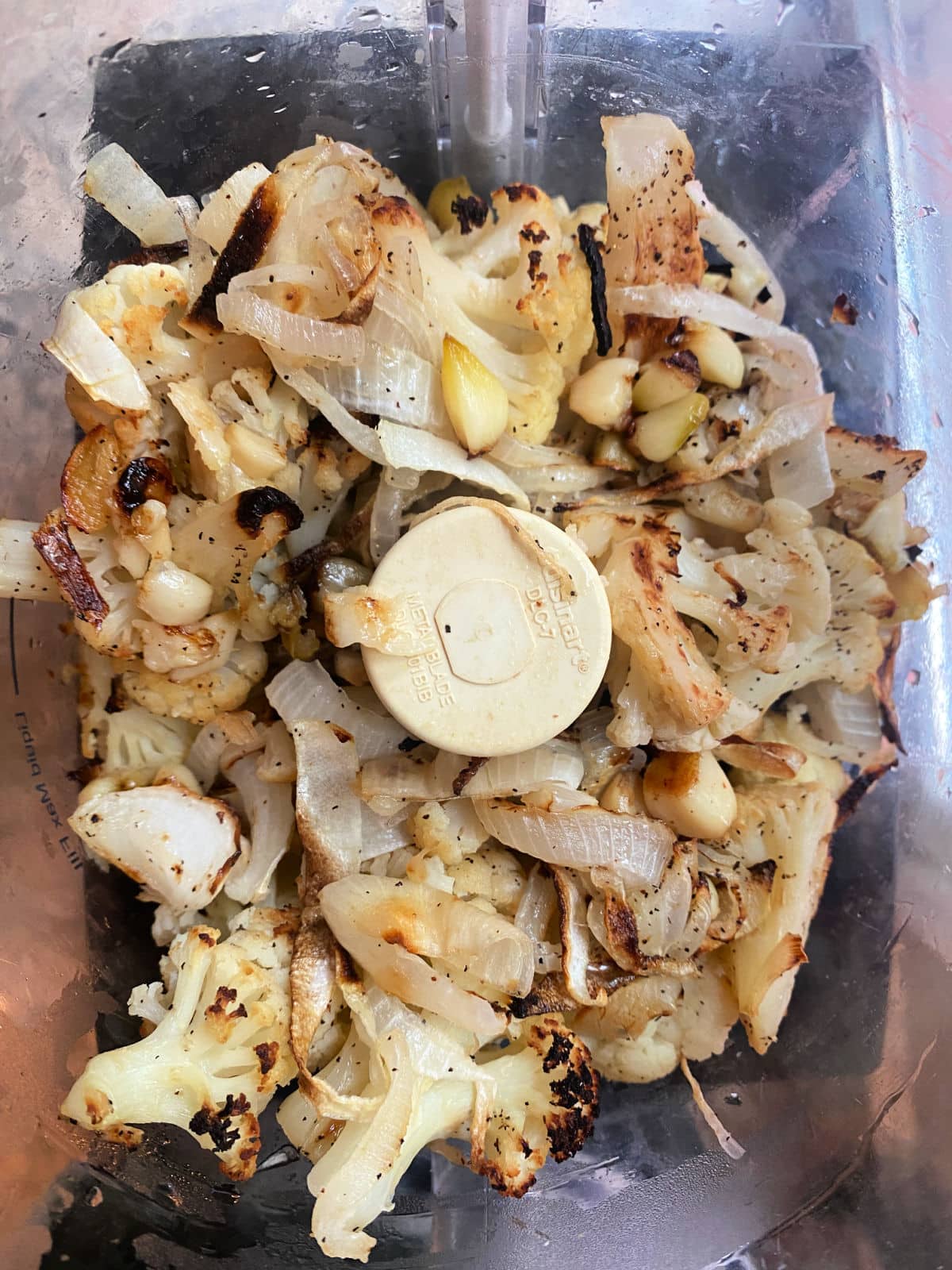Ingredients for cauliflower hummus in a food processor bowl