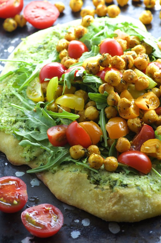 Topped with creamy cashew basil ricotta, arugula, tomatoes and spiced chickpeas and drizzled with a tangy pomegranate reduction, this Cashew Ricotta Pizza is like summer on a plate!