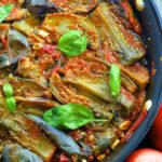 A close up view of a pan with Braised eggplant in Fresh Tomato Sauce - Vegan Passover recipes