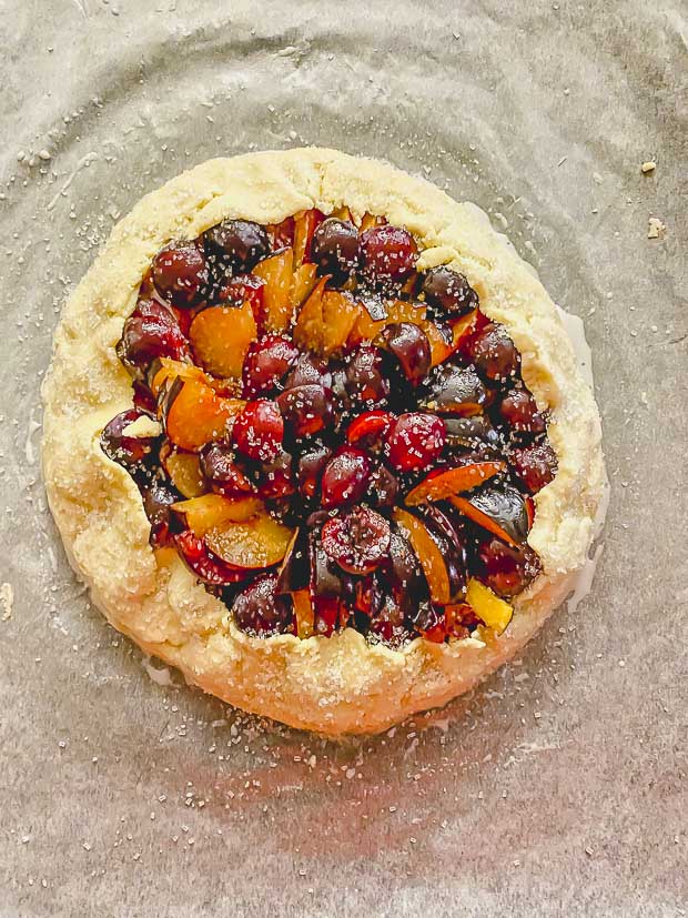 A stone fruit galette ready to go into the oven.