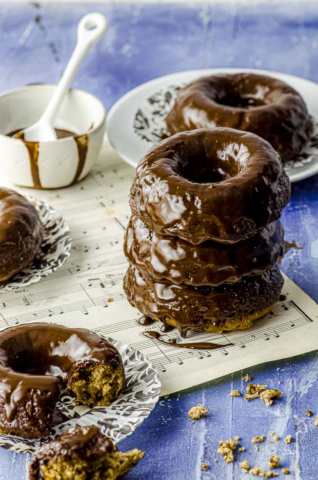 Side view of banana bread donuts with chocolate glazed piles on top of each other