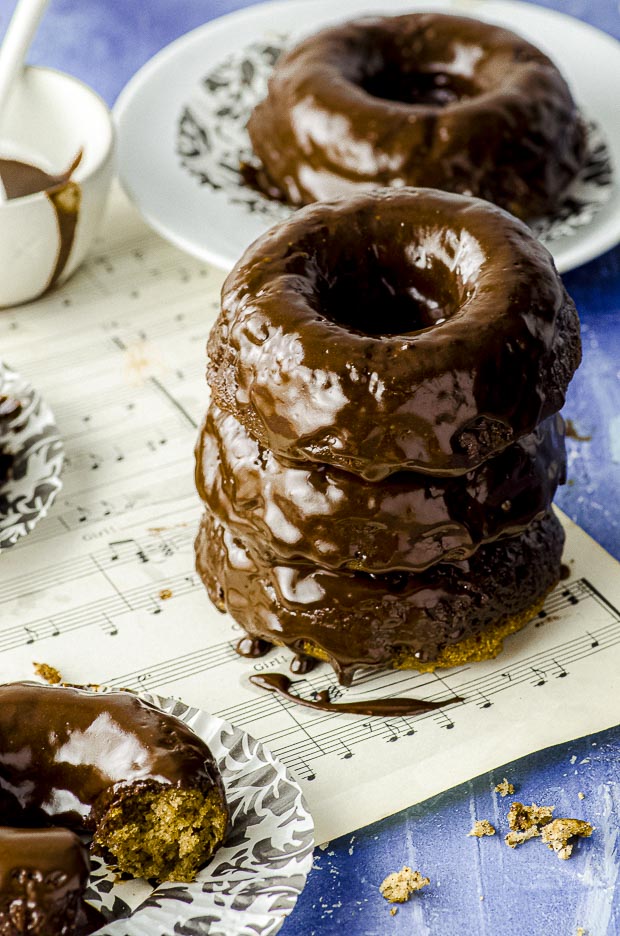Close up view of banana bread donuts with chocolate glazed piles on top of each other
