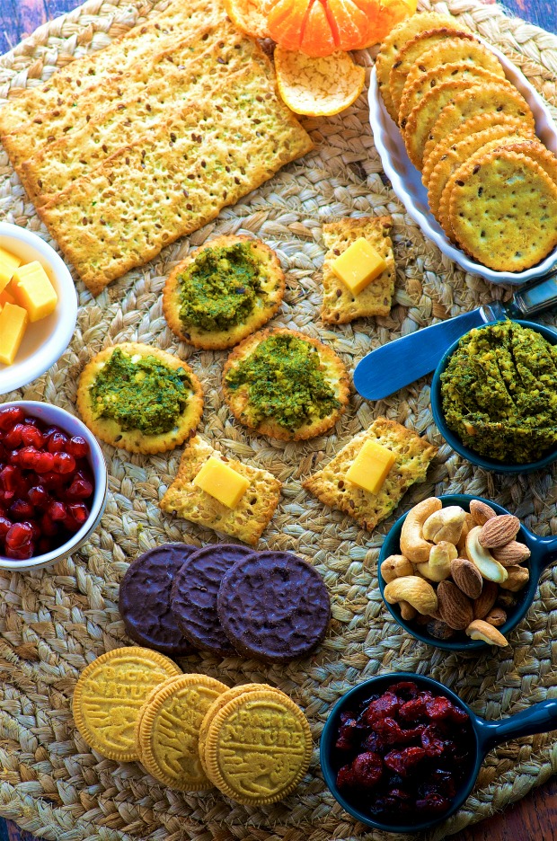 Close up view of a cheese, nuts, nut dip appetizer board