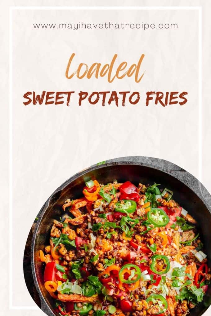 An overhead view of a cast iron skillet with loaded sweet potato fries