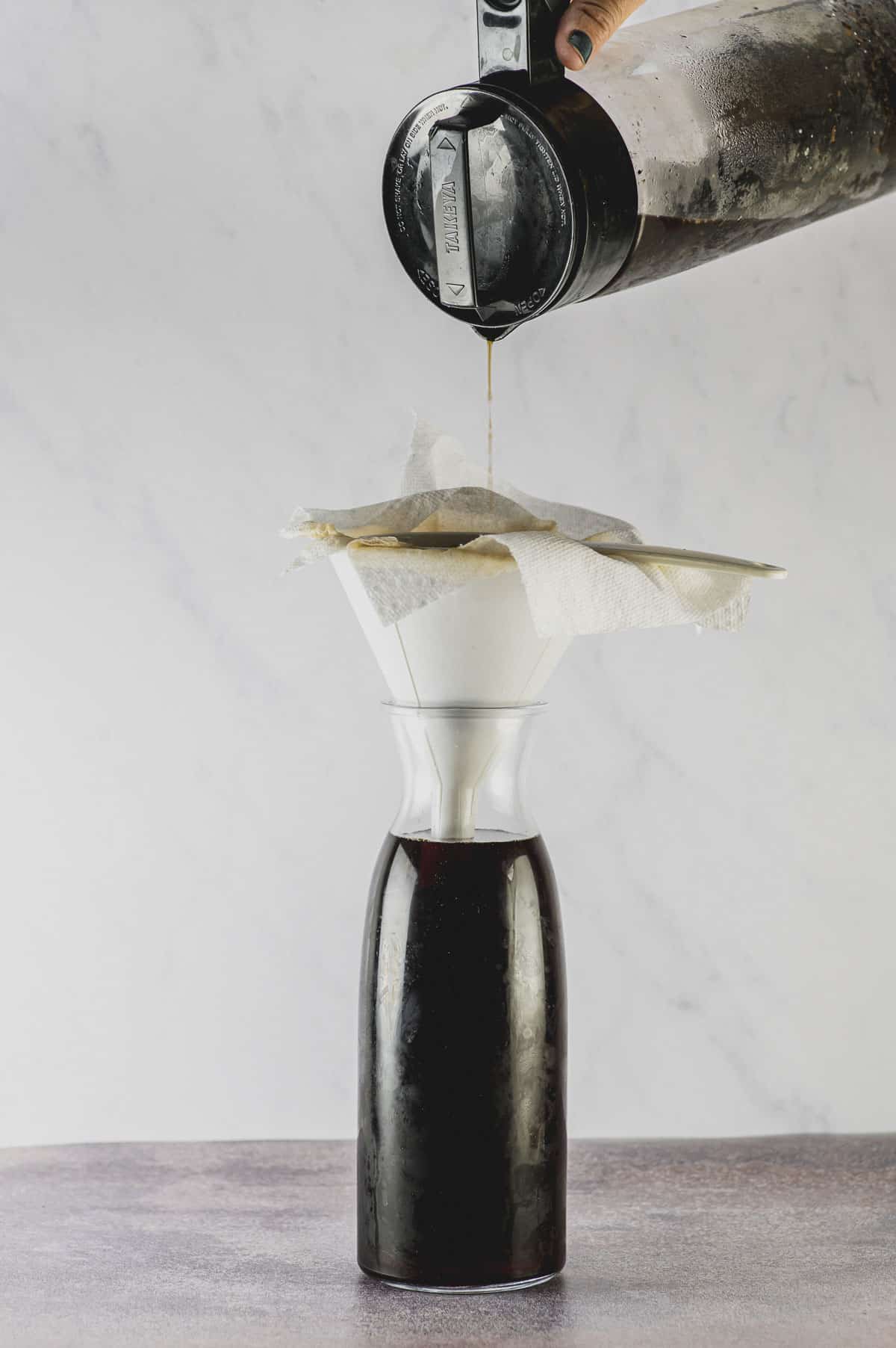filter cold brew coffee through a paper towel lined funnel