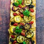 For this Hummus and Grilled Vegetable Pizza recipe, we marinated zucchini, yellow squash and Japanese eggplant in olive, lemon, garlic, coriander, cumin and ginger.  We spread a store bough crust with our home made hummus, instead of cheese for a healthy twist.