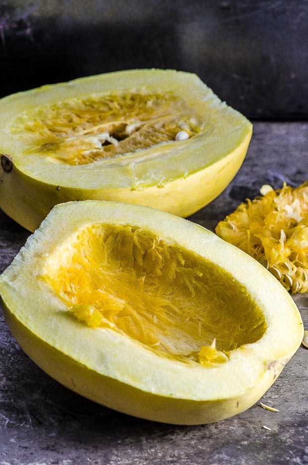 A spaghetti squash cut in half vertically with the seeds removed