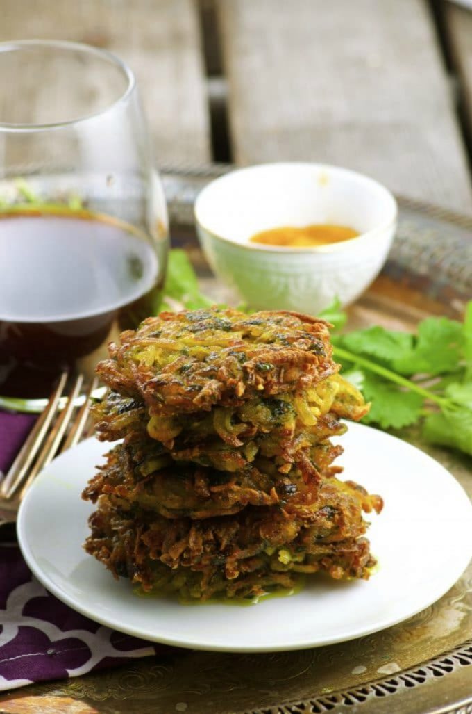 A small white plate with 6 vegan potato latkes stacked