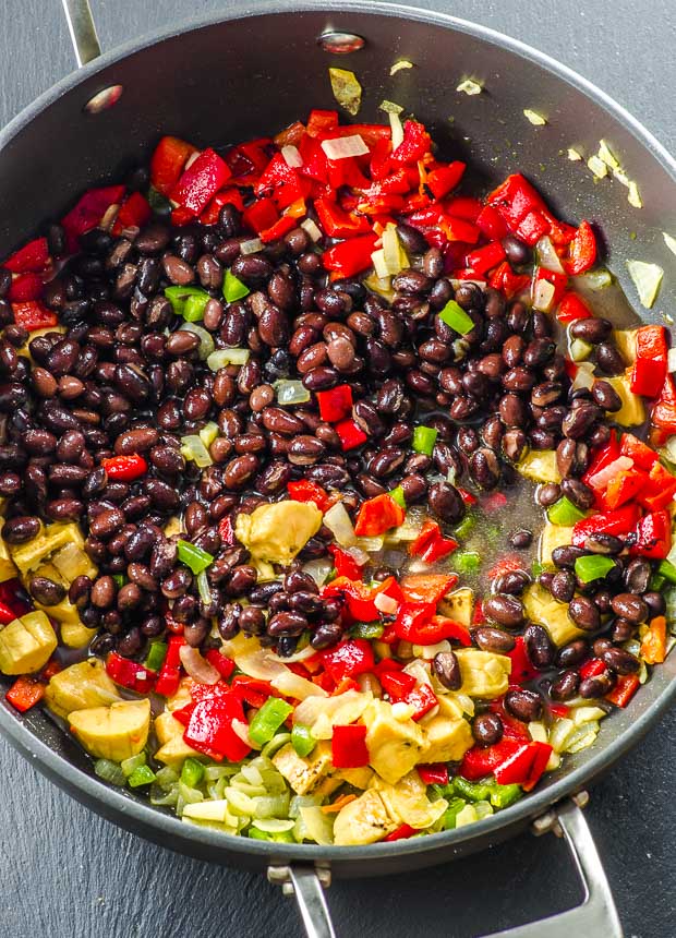 Black beans, plantains, roasted red peppers, jalapeno peppers and onions in a large deep skillet