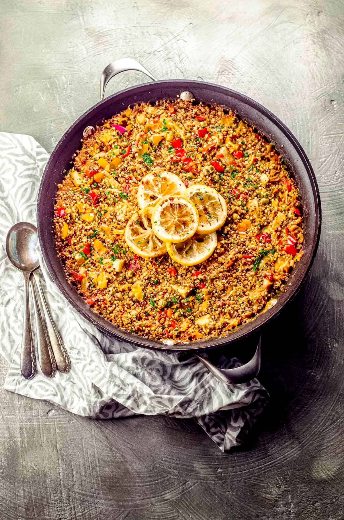 An overhead view of a skillet with quinoa paella