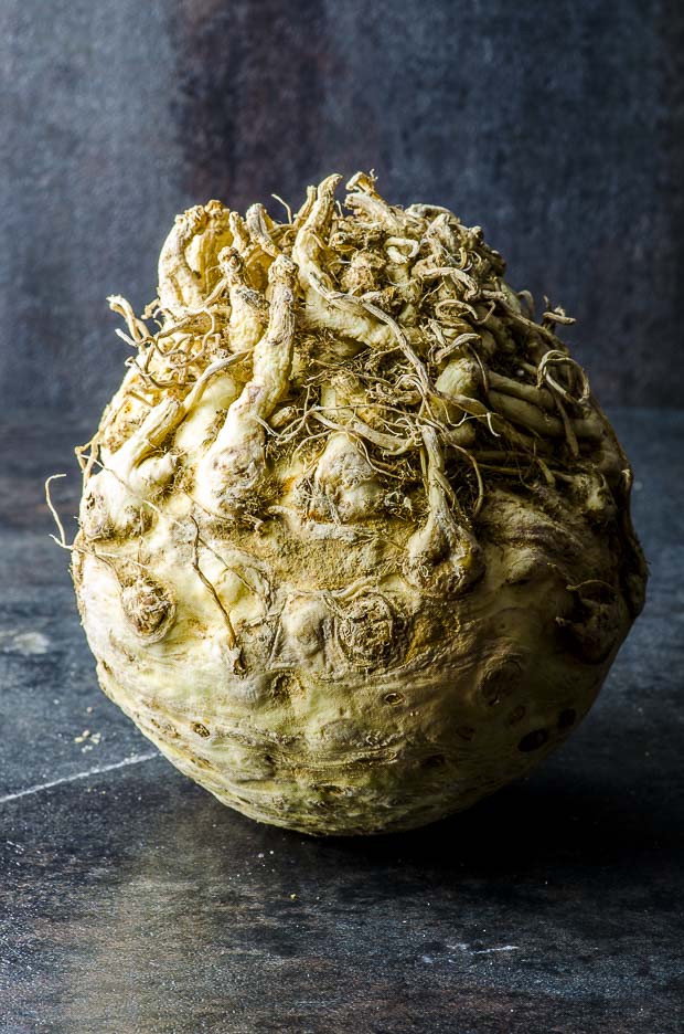 A celeriac ( celery root) in a black background