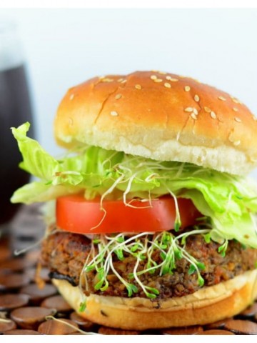 Side view of a black bean veggie burger in a hamburger bun. 4th of July recipes !