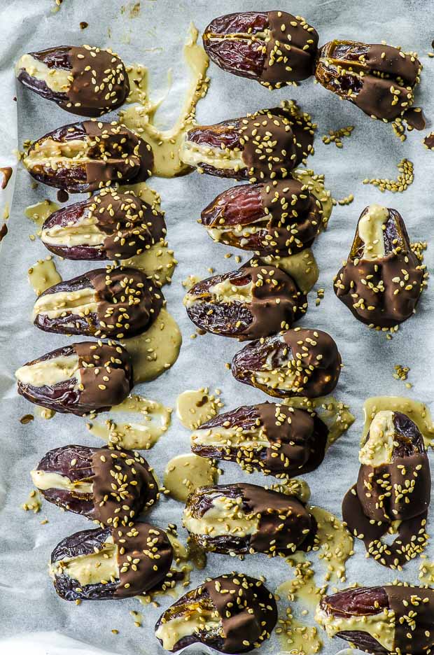 Halva Stuffed Dates Dipped in Chocolate on a baking sheet