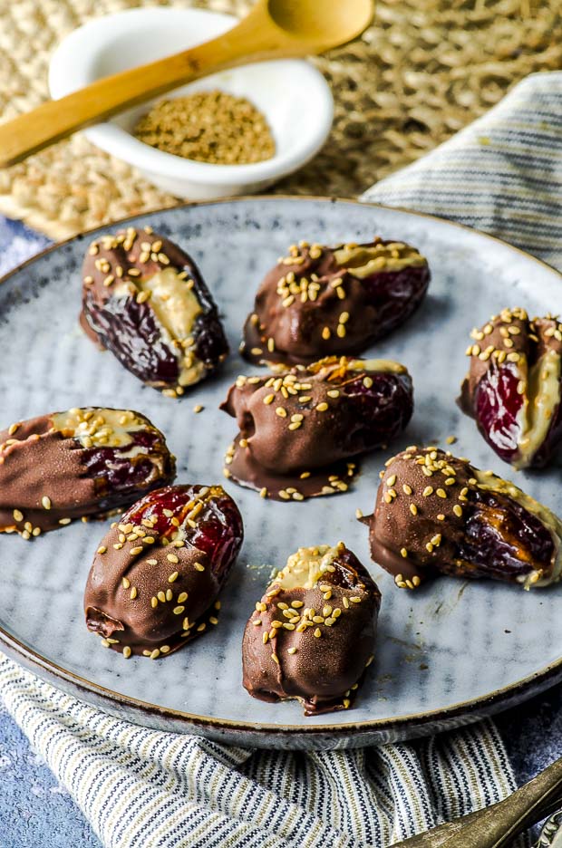 Halva Stuffed Dates Dipped in Chocolate on a grey plate