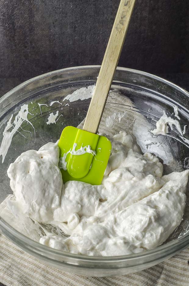 Picture of the marshmallows melted in a glass bowl with a green spatula