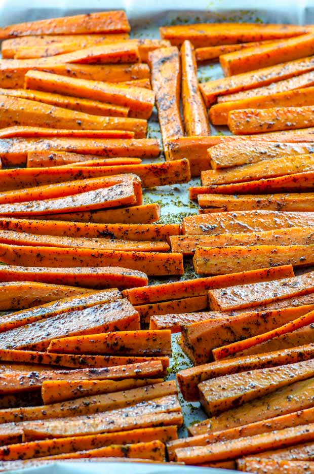 carrots seasoned with chili powder on a baking sheet