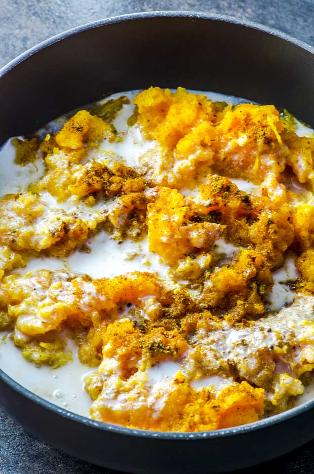 A pan with mashed butternut squash with spices and coconut milk