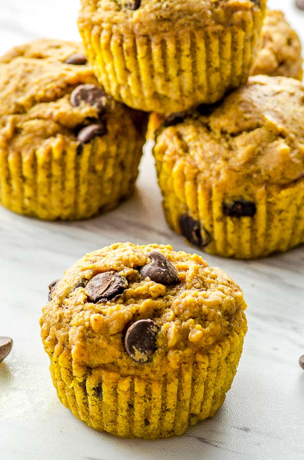 Close up of a pumpkin muffing with other pumpkin muffins on the back