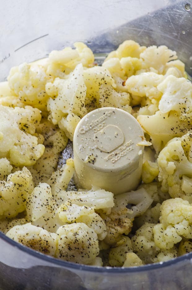 Roasted cauliflower in a food processor to make mashed cauliflower and herbed chestnuts