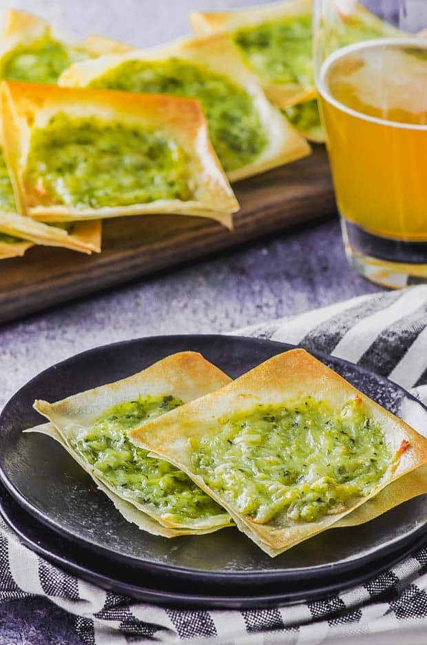 Crispy White pizza squares on a black plate