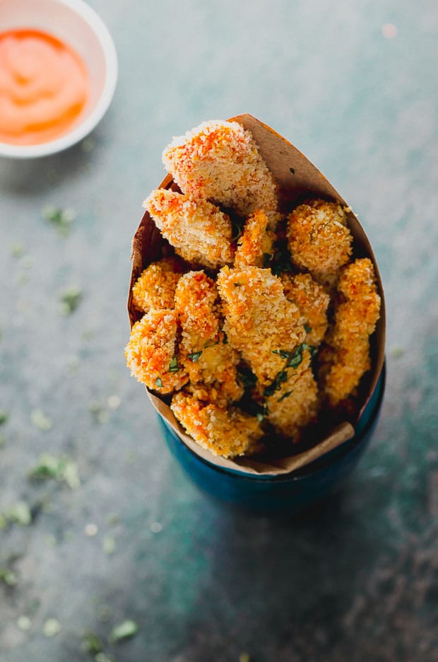 Buffalo Eggplant fries in a paper cone inside a glass
