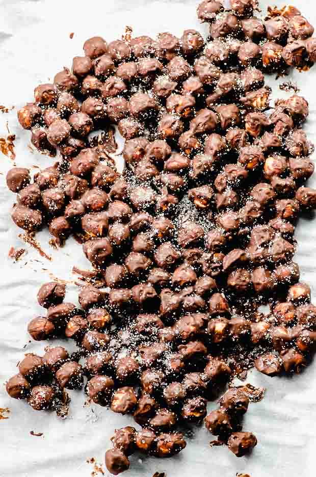 Frozen chocolate covered hazelnuts on a baking sheet