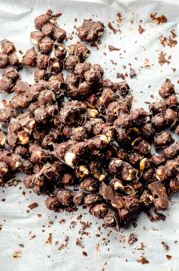 breaking chocolate covered hazelnuts into pieces