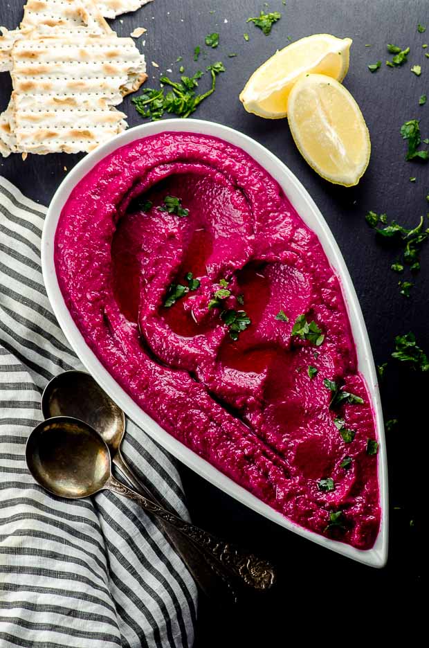 Bird's eye view of a white plate with cauliflower beet dip. One of our vegetarian Passover recipes.