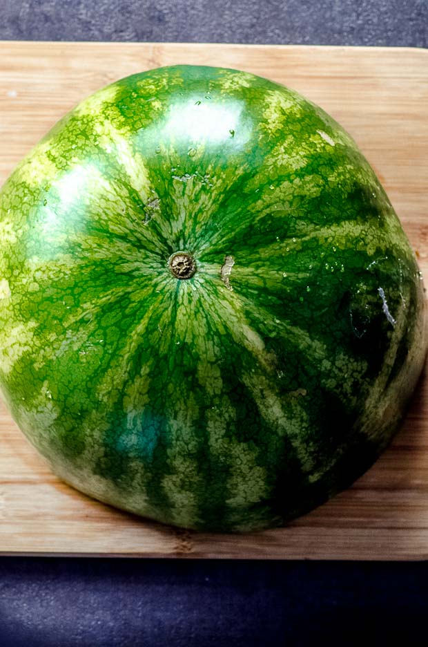 Half a watermelon on a cutting board #watermelon #watermelon salad