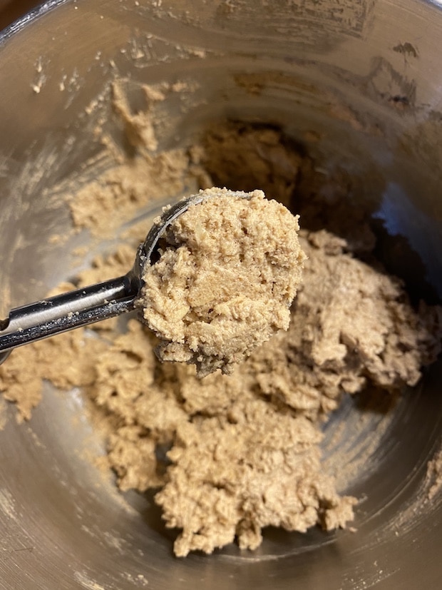 Measuring peanut butter oatmeal cookie dough with an ice cream scoop