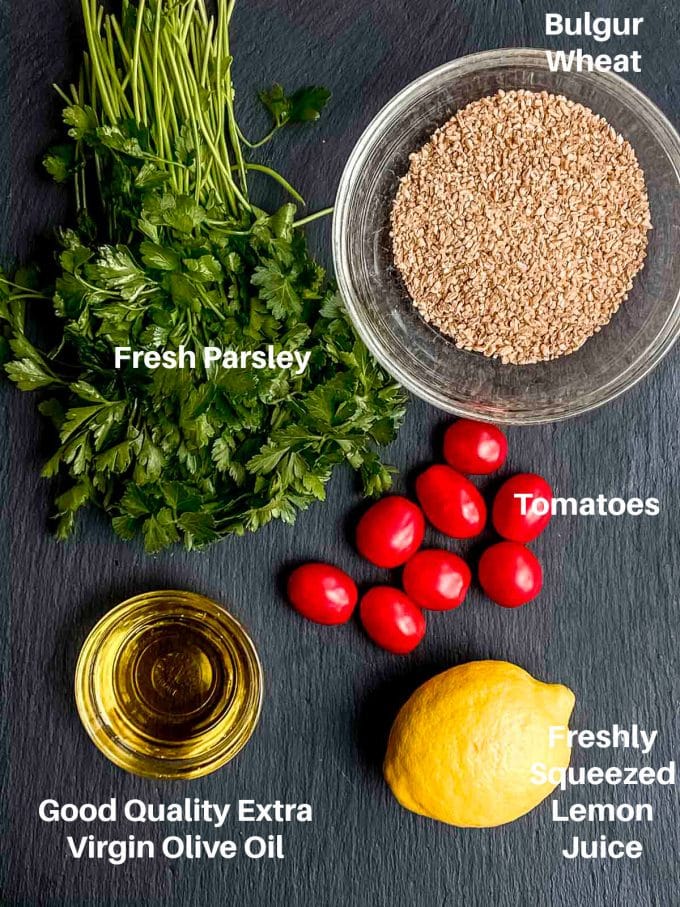 ingredients for tabouli: parsley, bulgar wheat, tomatoes, olive oil, and lemon