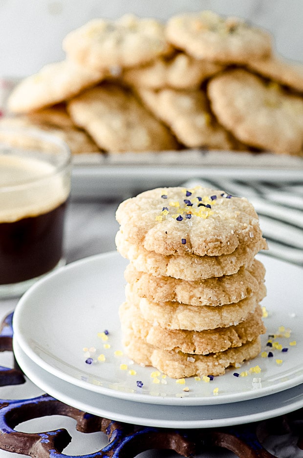 closeup view of a white plate with stacked vegan butter cookies