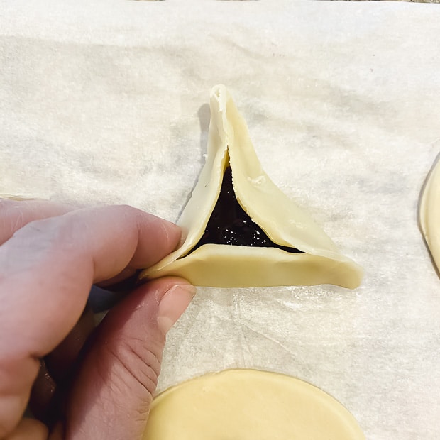 Pinching the last side of the hamantaschen dough