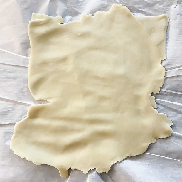 Rolling pie dough to ⅛" thick to make hamantaschen