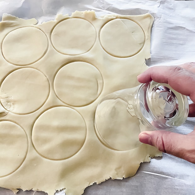 Using a glass make dough circles to make hamantaschen