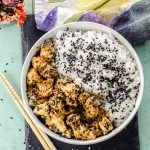 Bird's eye view of a bowl with rice and tahini miso eggplant