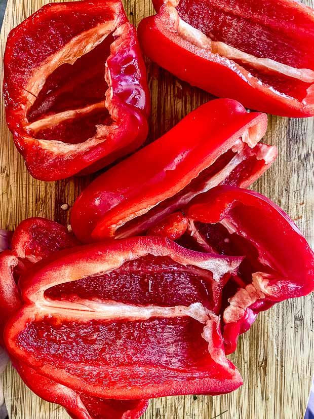 cut red bell peppers on a cutting board