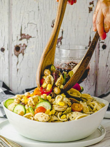 Tossing the ingredients of a pasta salad