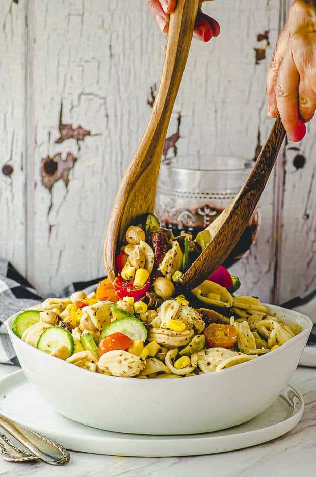 Tossing the ingredients of a pasta salad