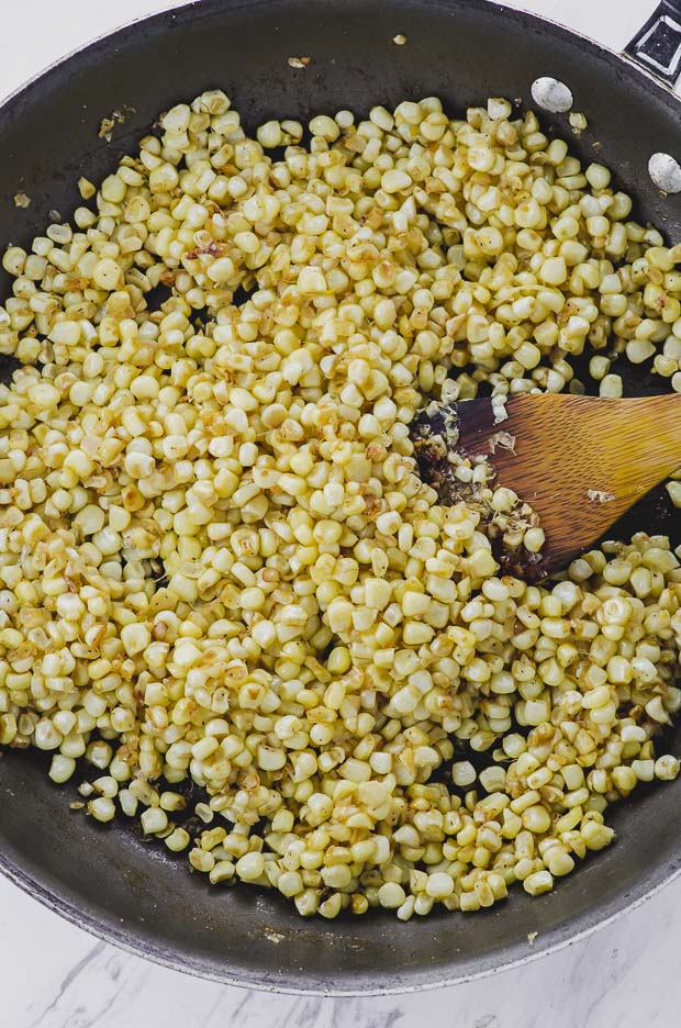 Sautéing corn kernels in a skillet