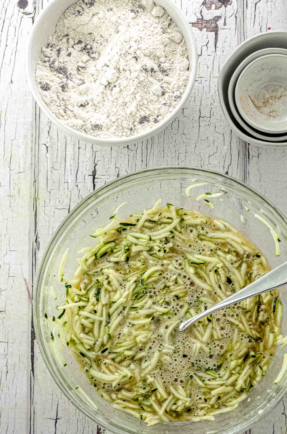 A bowl with the wet ingredients for zucchini bread